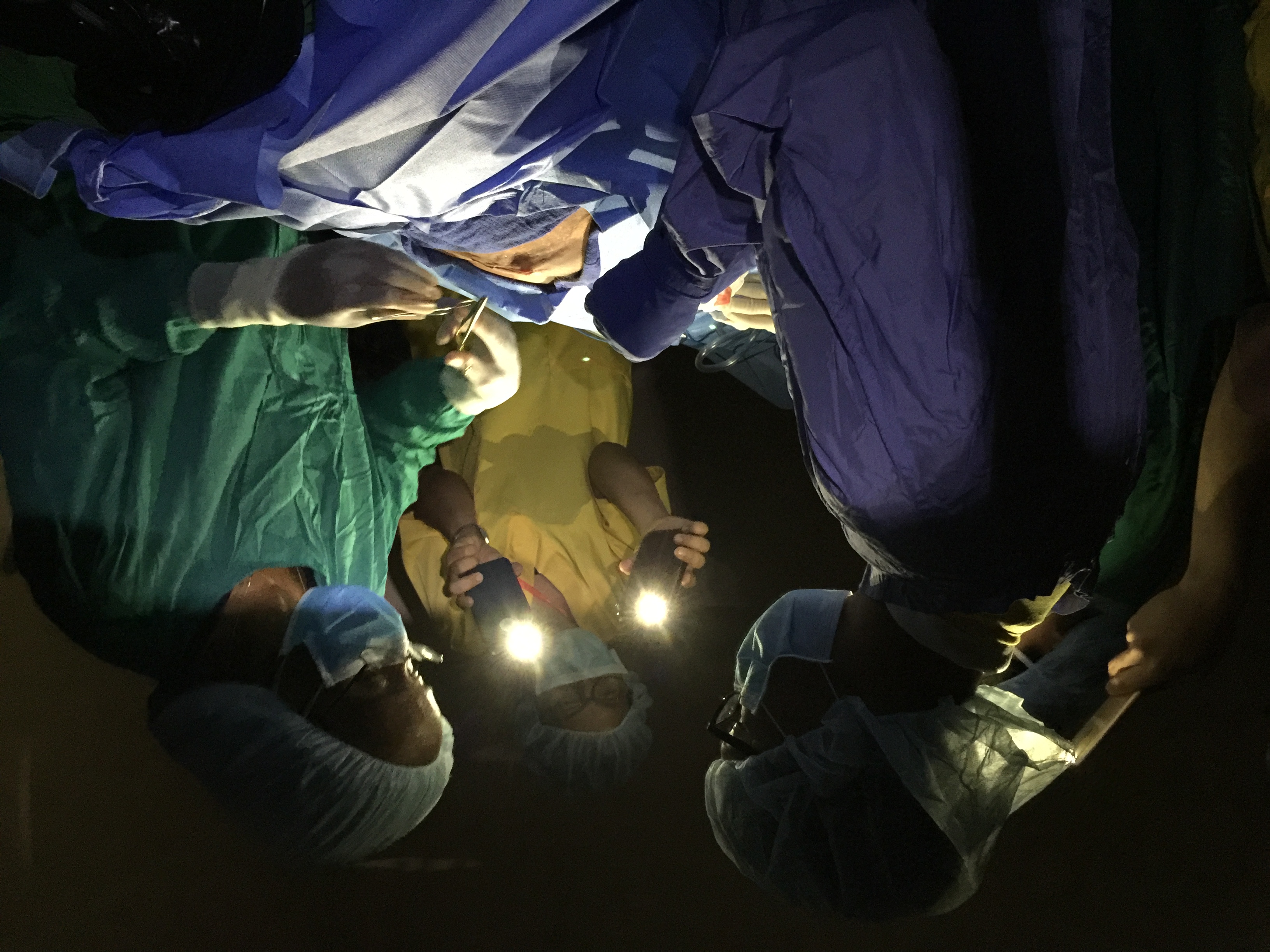 Power failures are common in rural Cambodia. One that occurred during surgery required improvisation, with several mobile phones providing light.